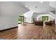 Bonus room with hardwood floors and plentiful light from the windows and glass patio doors at 193 Stonegate Trl, Carrollton, GA 30116