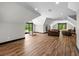 Spacious bonus room featuring hardwood floors, seating area, and windows at 193 Stonegate Trl, Carrollton, GA 30116