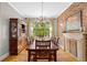 Dining room with exposed brick, hardwood floors, and a large window with views of the outdoors at 193 Stonegate Trl, Carrollton, GA 30116