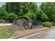 Stonegate Farms entrance featuring stone pillars, iron gates and manicured landscaping at 193 Stonegate Trl, Carrollton, GA 30116