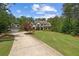 Inviting exterior features a manicured lawn leading to a beautiful two-story home with a detached three-car garage at 193 Stonegate Trl, Carrollton, GA 30116
