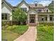 Close up of a charming two-story home with a manicured front yard, inviting porch, and mature landscaping at 193 Stonegate Trl, Carrollton, GA 30116