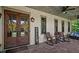 Inviting front porch with rocking chairs, ceiling fan, and double doors with wreaths at 193 Stonegate Trl, Carrollton, GA 30116