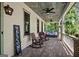 Cozy front porch features rocking chairs, ceiling fans, and views of the lush green surroundings at 193 Stonegate Trl, Carrollton, GA 30116