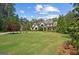 Beautiful two-story home with a lush lawn and mature trees under a blue sky at 193 Stonegate Trl, Carrollton, GA 30116