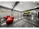 Garage with car lift, epoxy floors, multiple auto bays and a seating area at 193 Stonegate Trl, Carrollton, GA 30116