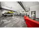Spacious garage featuring stainless steel refrigerator, car lift, multiple auto bays, and epoxy floors at 193 Stonegate Trl, Carrollton, GA 30116