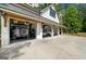 Attached four-car garage with cars parked inside, showcasing its practical use at 193 Stonegate Trl, Carrollton, GA 30116