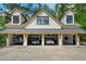 Five-car garage is being used to store cars, and a work bench, with living area above at 193 Stonegate Trl, Carrollton, GA 30116