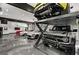 Garage showcasing the convenience of a car lift, highlighting its functionality for car enthusiasts at 193 Stonegate Trl, Carrollton, GA 30116