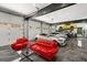 Inside the garage is a red seating area, multiple vehicles, and a clean design at 193 Stonegate Trl, Carrollton, GA 30116