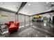 Inside this luxury garage, there is red seating and multiple vehicles that show it is well-equipped at 193 Stonegate Trl, Carrollton, GA 30116