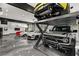 Car lift and auto bays shown in garage featuring painted epoxy floor and lift at 193 Stonegate Trl, Carrollton, GA 30116