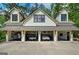 A front view of the house displaying an attached four-car garage with cars visible inside at 193 Stonegate Trl, Carrollton, GA 30116