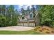 Charming home showcasing an expansive paved driveway leading to an attached four-car garage at 193 Stonegate Trl, Carrollton, GA 30116