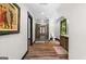 Hallway with hardwood floors that leads to a bathroom with a walk-in shower and glass door at 193 Stonegate Trl, Carrollton, GA 30116