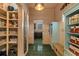 Hallway with wood paneling, polished green tile flooring, and cabinetry for storage and pantry at 193 Stonegate Trl, Carrollton, GA 30116