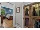Hallway view leading to a bedroom with hardwood floors, a king bed, and closet with sliding wooden doors at 193 Stonegate Trl, Carrollton, GA 30116