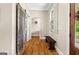 Hallway with hardwood floors, a bench, window, and sliding door storage at 193 Stonegate Trl, Carrollton, GA 30116