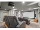 Inviting home theater boasts a large projector screen, comfortable seating, and modern entertainment setup at 193 Stonegate Trl, Carrollton, GA 30116