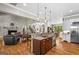 Open-concept kitchen with stainless steel appliances, central island, and seamless flow to the living area at 193 Stonegate Trl, Carrollton, GA 30116