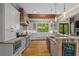 Open kitchen with white cabinets, stainless steel appliances, and an island with a breakfast bar at 193 Stonegate Trl, Carrollton, GA 30116