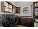 Well-equipped laundry room featuring modern washer/dryer, built-in cabinets, and ample storage space at 193 Stonegate Trl, Carrollton, GA 30116