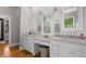 Main bathroom featuring dual sink vanities, marble countertops, and a walk-in shower at 193 Stonegate Trl, Carrollton, GA 30116
