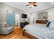 Main bedroom features hardwood floors, sitting chair, and view into bathroom at 193 Stonegate Trl, Carrollton, GA 30116