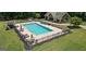 Beautiful backyard featuring a large rectangular pool with lounge chairs, a pool house, and landscaping at 193 Stonegate Trl, Carrollton, GA 30116