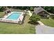 Aerial view of a backyard with an in-ground pool, lush green lawn, and a pool house at 193 Stonegate Trl, Carrollton, GA 30116