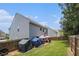 A fenced backyard with a patio area for outdoor gatherings, with green grass and space for recreation at 210 Kestrel Cir, Covington, GA 30014