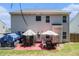 Two story home with back patio featuring outdoor dining set at 210 Kestrel Cir, Covington, GA 30014
