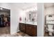 Spacious bathroom with double vanity, toilet room, and walk-in closet for ample storage at 210 Kestrel Cir, Covington, GA 30014