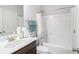 Bright bathroom featuring a shower and tub, and vanity with sink at 210 Kestrel Cir, Covington, GA 30014
