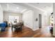 Elegant dining room featuring hardwood floors, wainscoting, tray ceiling, and stylish furnishings for sophisticated dining at 210 Kestrel Cir, Covington, GA 30014