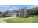 Charming two-story home with a two-car garage, brick facade, and well-manicured lawn at 210 Kestrel Cir, Covington, GA 30014