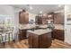 Lovely kitchen featuring stainless steel appliances, granite countertops, and rich brown cabinetry at 210 Kestrel Cir, Covington, GA 30014