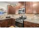 Bright kitchen features stainless steel appliances, granite countertops, gas range, and brick-style backsplash at 210 Kestrel Cir, Covington, GA 30014