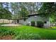 A backyard featuring a patio area surrounded by lush greenery and trees, creating a private outdoor space at 3408 Chestnut Dr, Atlanta, GA 30340
