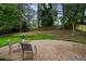 Secluded backyard with a stone patio and lush greenery, perfect for outdoor relaxation at 3408 Chestnut Dr, Doraville, GA 30340