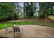A gravel patio area surrounded by lush trees and grass offers a tranquil outdoor space at 3408 Chestnut Dr, Atlanta, GA 30340