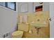 Yellow bathroom features tiled wall, sink, and toilet at 3408 Chestnut Dr, Doraville, GA 30340