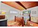 Cozy bedroom features a wood ceiling, two windows, and carpet at 3408 Chestnut Dr, Doraville, GA 30340