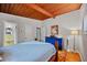 Bedroom featuring wood plank ceiling, hardwood floors and a blue accent dresser at 3408 Chestnut Dr, Doraville, GA 30340