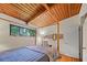 Bedroom with hardwood floors, wood plank ceilings and a window with view at 3408 Chestnut Dr, Doraville, GA 30340