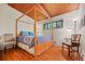 Bedroom features wood plank ceilings, hardwood floors and a decorative wood frame bed at 3408 Chestnut Dr, Doraville, GA 30340