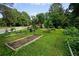 Doraville Community Garden with rich soil, green grass, and mature trees at 3408 Chestnut Dr, Doraville, GA 30340