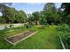 Community garden featuring several raised garden beds surrounded by lush green grass and trees at 3408 Chestnut Dr, Atlanta, GA 30340
