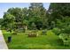 Doraville's Unity Garden features a wooded area, raised garden beds, and lush green grass at 3408 Chestnut Dr, Doraville, GA 30340